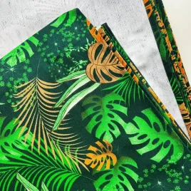 tkanina-lezakowa-liscie-monstera-z-pomaranczowym-na-czarnym-tle