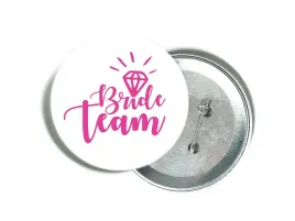 przypinka-biala-z-rozowym-napisem-bride-team-i-diamentem