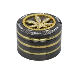 czarny-mlynek-do-tytoniu-grinder-metalowy-z-zloto-srebrnym-listkiem-marychy
