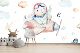 fototapeta-dla-dzieci-na-wymiar-chlopiec-w-samolote-nad-kolorowymi-domkami