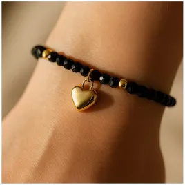 zlota-bransoletka-damska-na-reke-z-czarnymi-koralikami-celebrytka