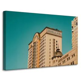 obraz-na-plotnie-architektura-hotel-90x60-cm-zolty-niebieski-kolor-budynki